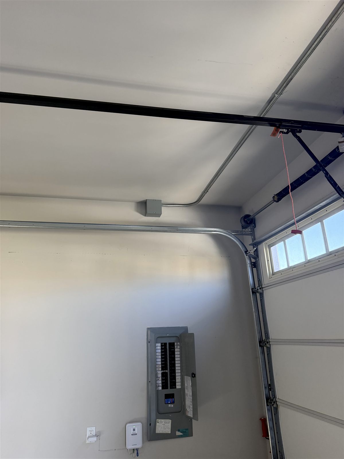 Residential electrical panel and surface-mounted conduit supplying a home EV charging circuit